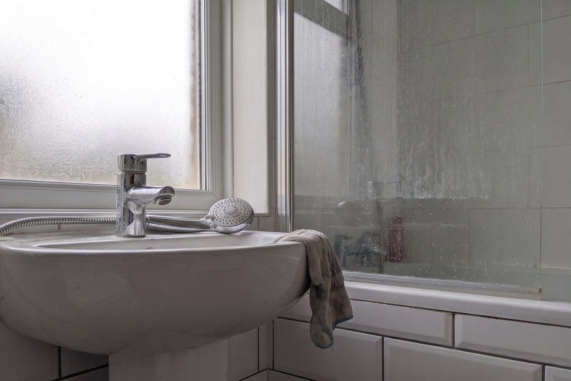 Bathroom being deep cleaned with limescale coming off the taps and shower screen