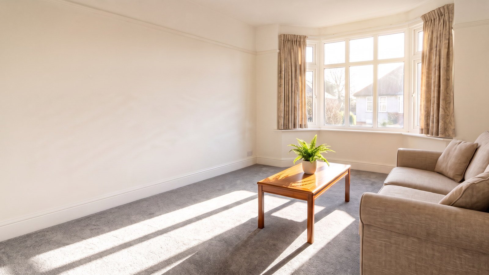 Freshly cleaned living room in a Birmingham semi with the floor swept and cushions straightened